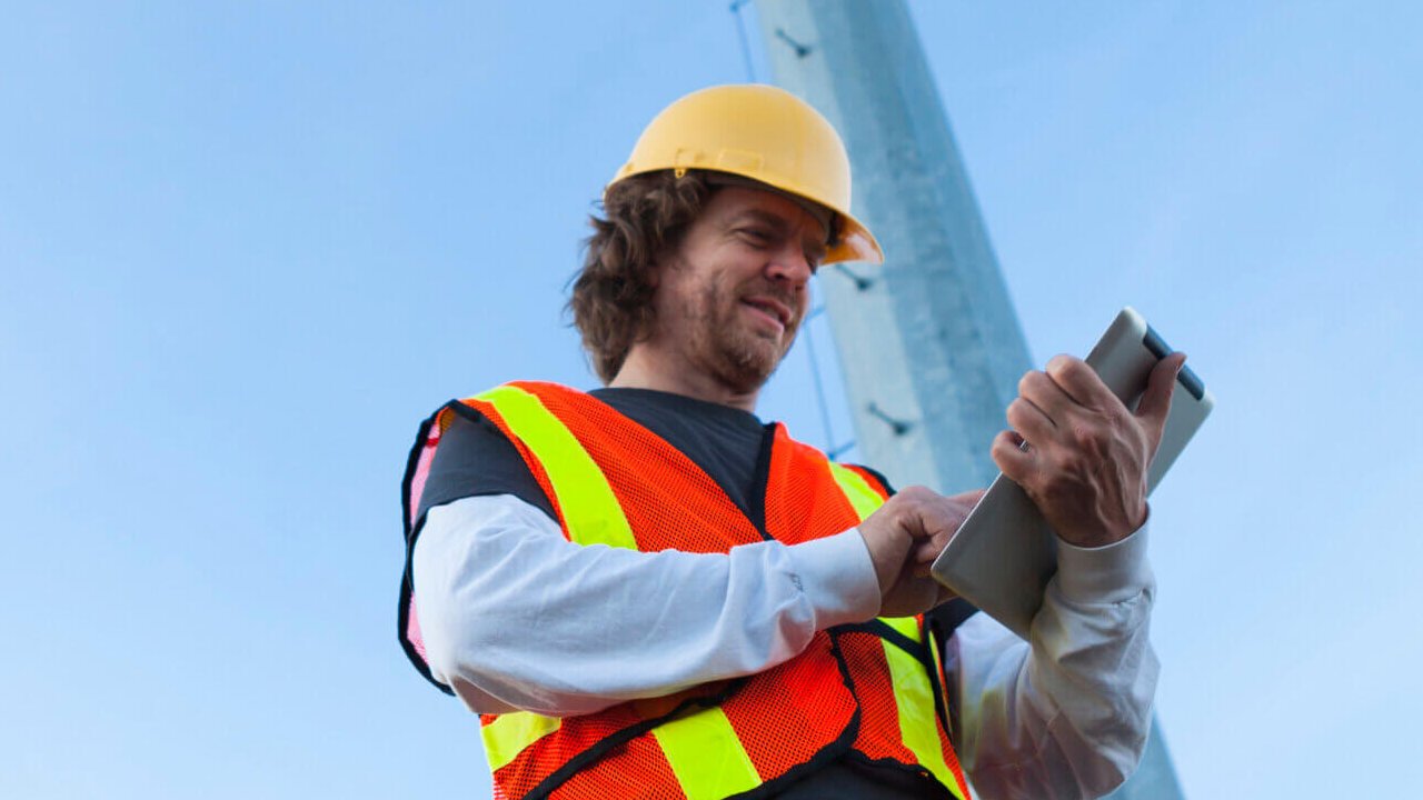 Technician using Tablet Computer to Monitor a Cell Tower
